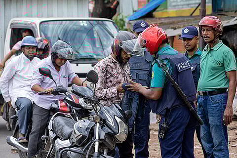 Police inspect a biker's bag